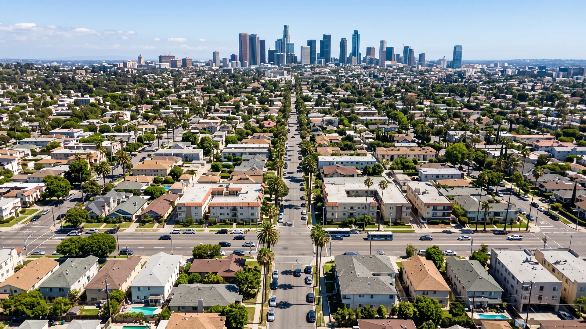 AI illustration: aerial view over a Los Angeles neighborhood with downtown on the horizon